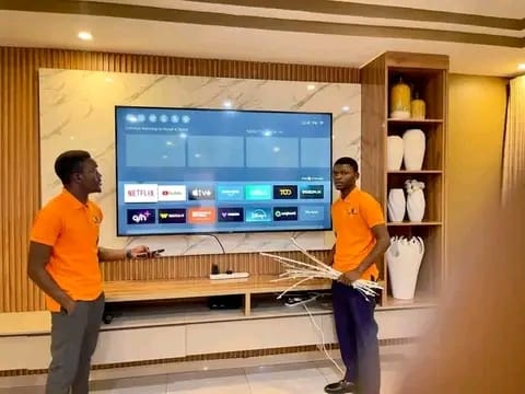 Bluetech TV Repairs technicians mounting and installing a TV in a customer's home