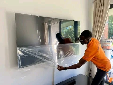 Bluetech TV Repairs technician unwrapping a new frameless OLED TV